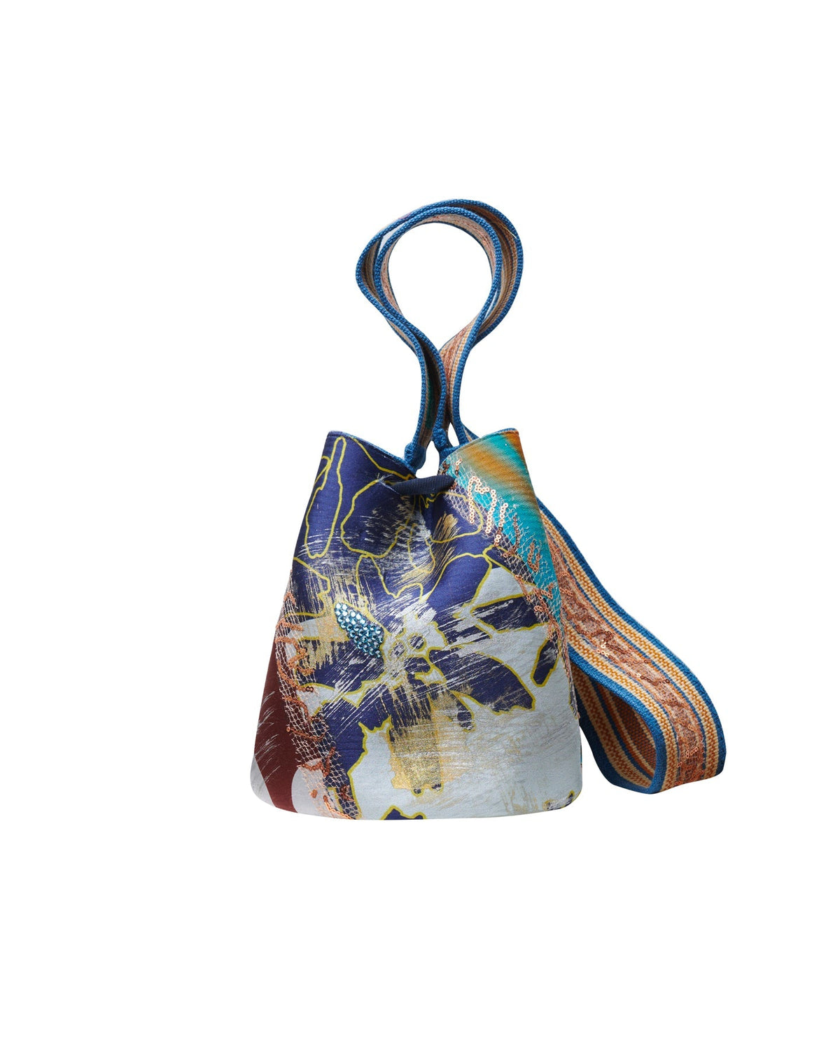 The Mochila Laaput Blue is a small bucket bag adorned with colorful diagonal stripes, featuring a blue ribbon tie on the front and a hand-woven strap that showcases exquisite Wayuu craftsmanship.
