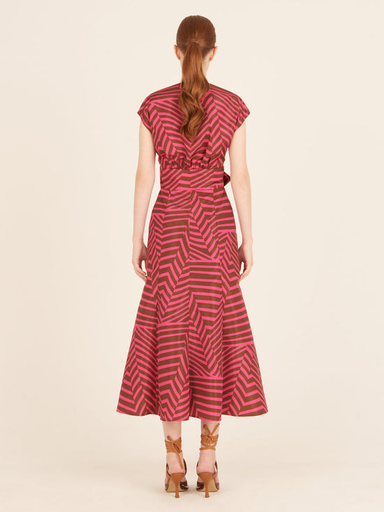 A feminine Toledo Dress Fuchsia Cacao with a bow, perfect for any occasion.