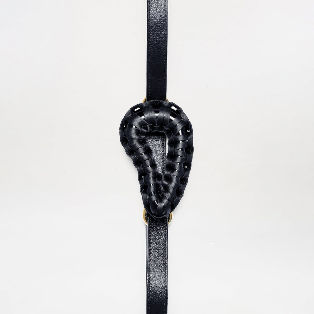 The Renata Belt features a black woven leather loop in a teardrop shape, centered on a vertical black leather strap, shown against a plain white background.