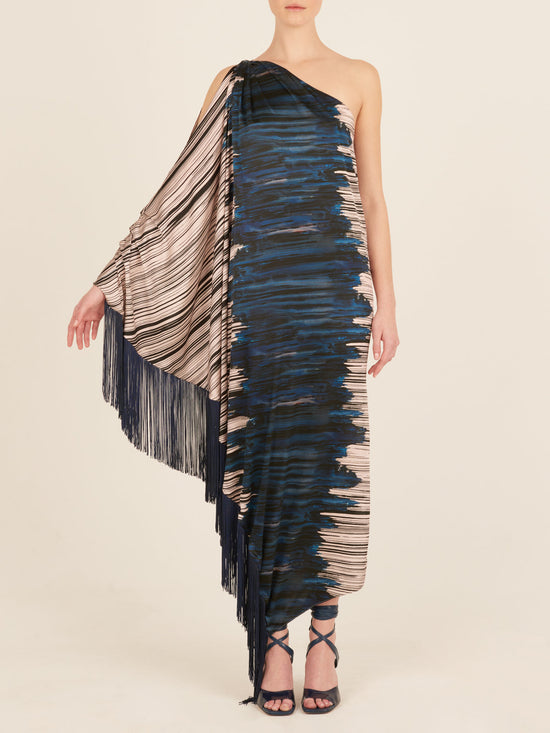 A blue and white fringed Alana Dress Indigo Linear, part of the Fall 2023 collection, is displayed on a mannequin with navy-blue fringes.