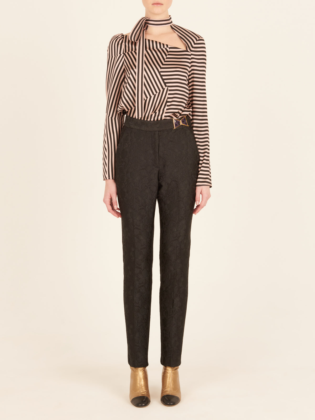 Orion Pant Black high-waisted pants with a patterned design and a gold detail on the waistband.