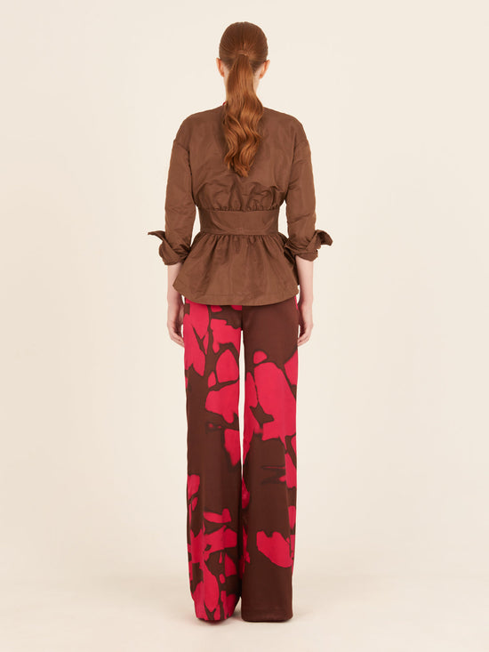 A woman's pink and brown Andie Pant Fuchsia Cacao with a high-waisted silhouette.