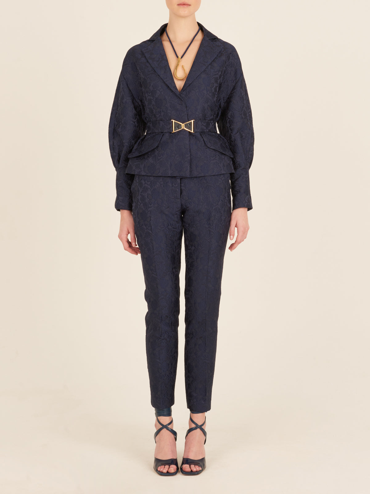 A Sorrento Jacket Navy with a gold buckle.