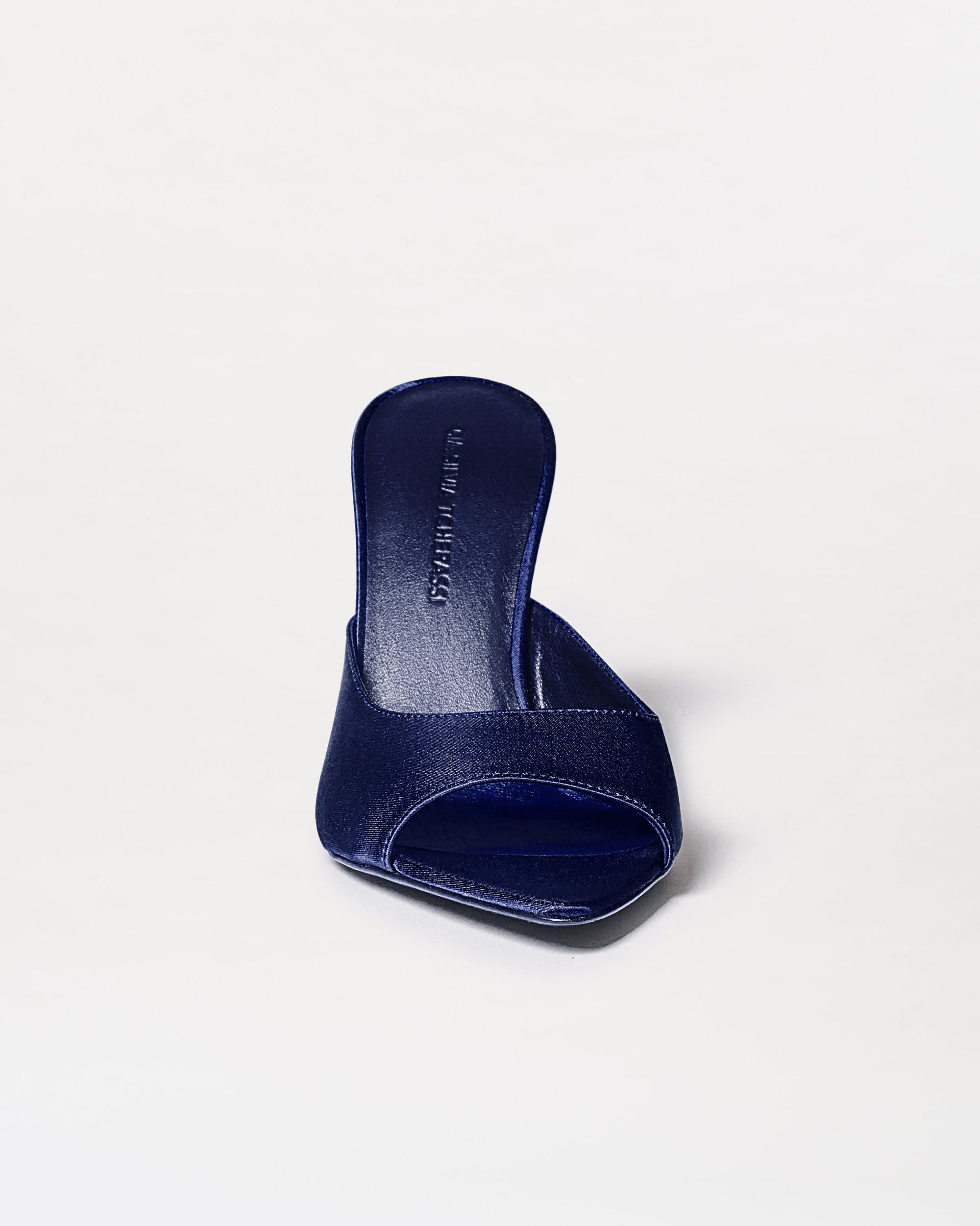 The Perni Heels, shown in dark blue against a white background, are minimalist open-toe slip-on sandals with a wide toe strap and a front-facing view.