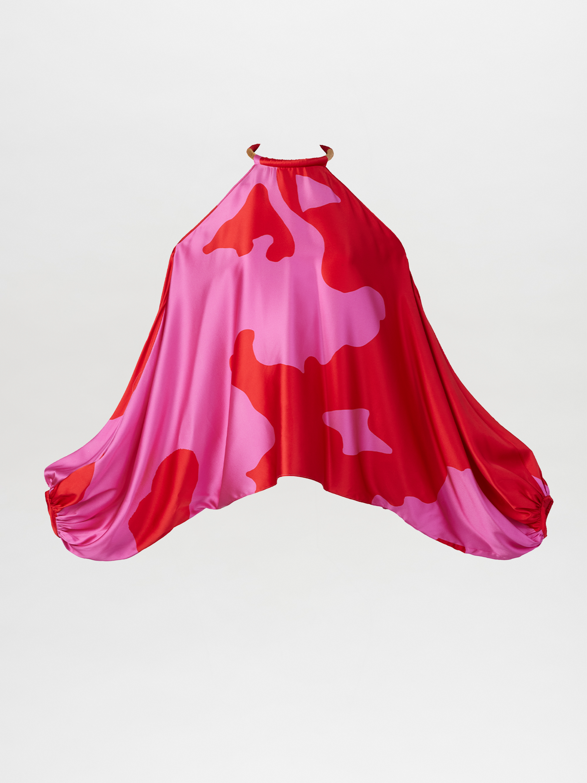 La blusa Janina con estampado floral rosa bermellón es una blusa holgada sin mangas con escote alto y laterales drapeados que presenta llamativas flores abstractas en tonos rosas y rojos sobre un fondo blanco liso.