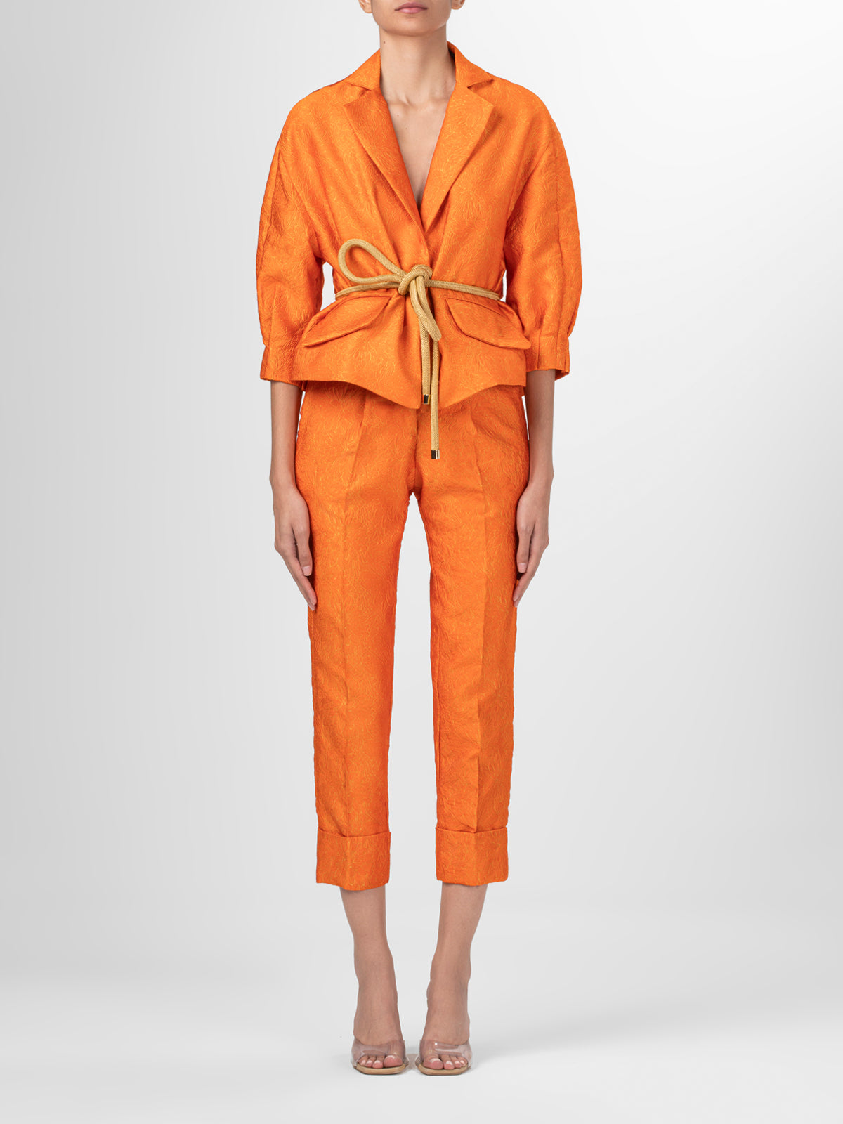 A pair of Moad Pant Orange Petal with pleating details.