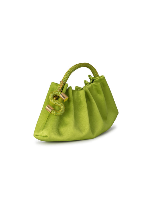 The ST Clutch Lime, a lime green handbag with a woven top handle and gold accents, including a chain adorned with decorative gold charms, will ship by August 19th.