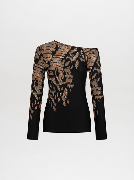 A woman with straight, pulled-back hair poses in a Sabra Blouse Black Abstract Animal Print with decorative gold elements. She holds a black item over her shoulder against a plain white background. This stunning outfit is available for pre-order and will ship by date November 15th, 2024.