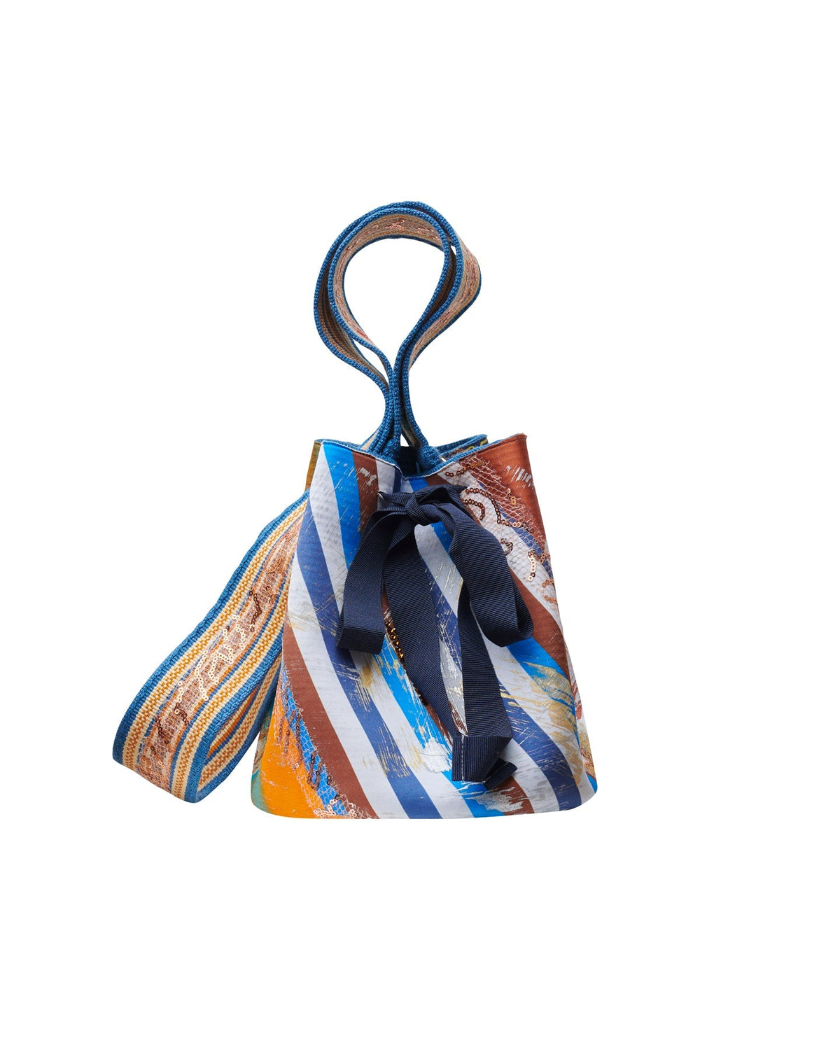 The Mochila Laaput Blue is a small bucket bag adorned with colorful diagonal stripes, featuring a blue ribbon tie on the front and a hand-woven strap that showcases exquisite Wayuu craftsmanship.