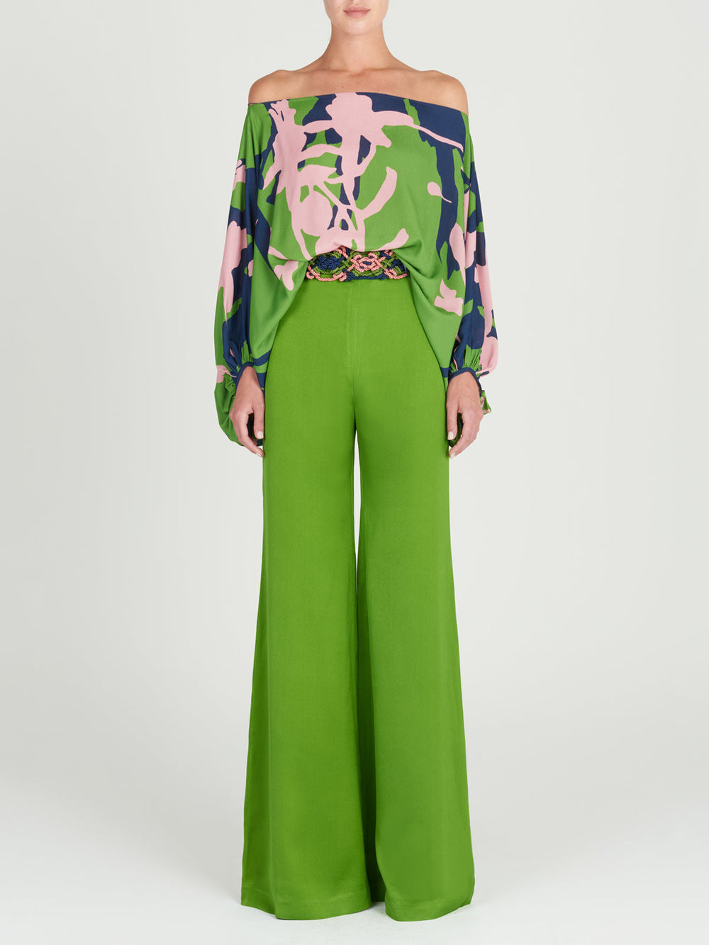 A woman's versatile high-rise Grotte Pant Lime wide leg pants on a white background.